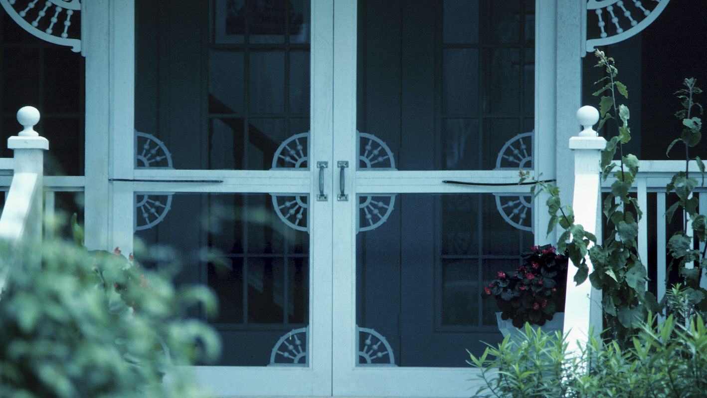 A white door with a clock on the side of it